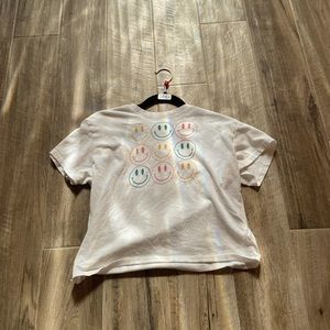 A white shirt with different color smiley faces on it T shirt